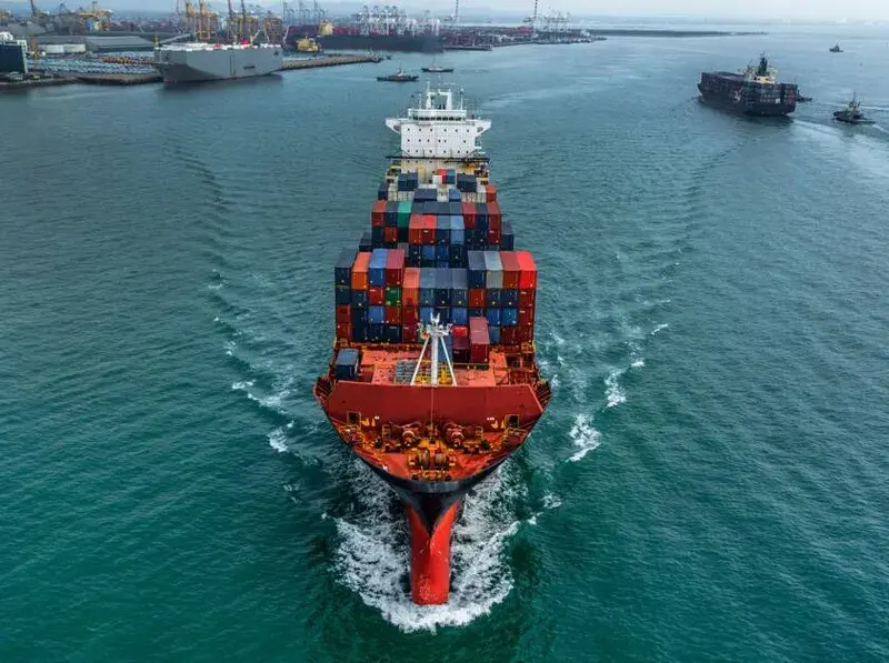 Container ship stacked with cargo containers seen from the bow