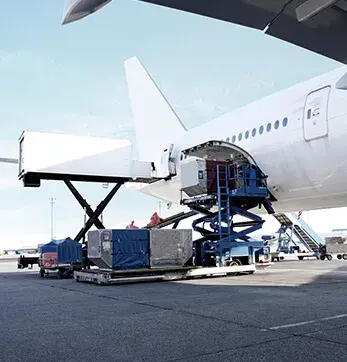High-loader lifting cargo containers into a freighter aircraft